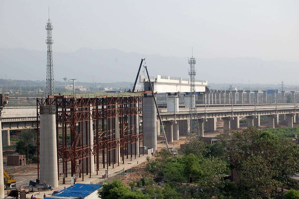 China high speed rail network - A bridge with steel through-girders being pushed into position by applying of the incremental shifting process, over three rail lines with ongoing operation on the Datong-Xi’an Passenger Dedicated Line