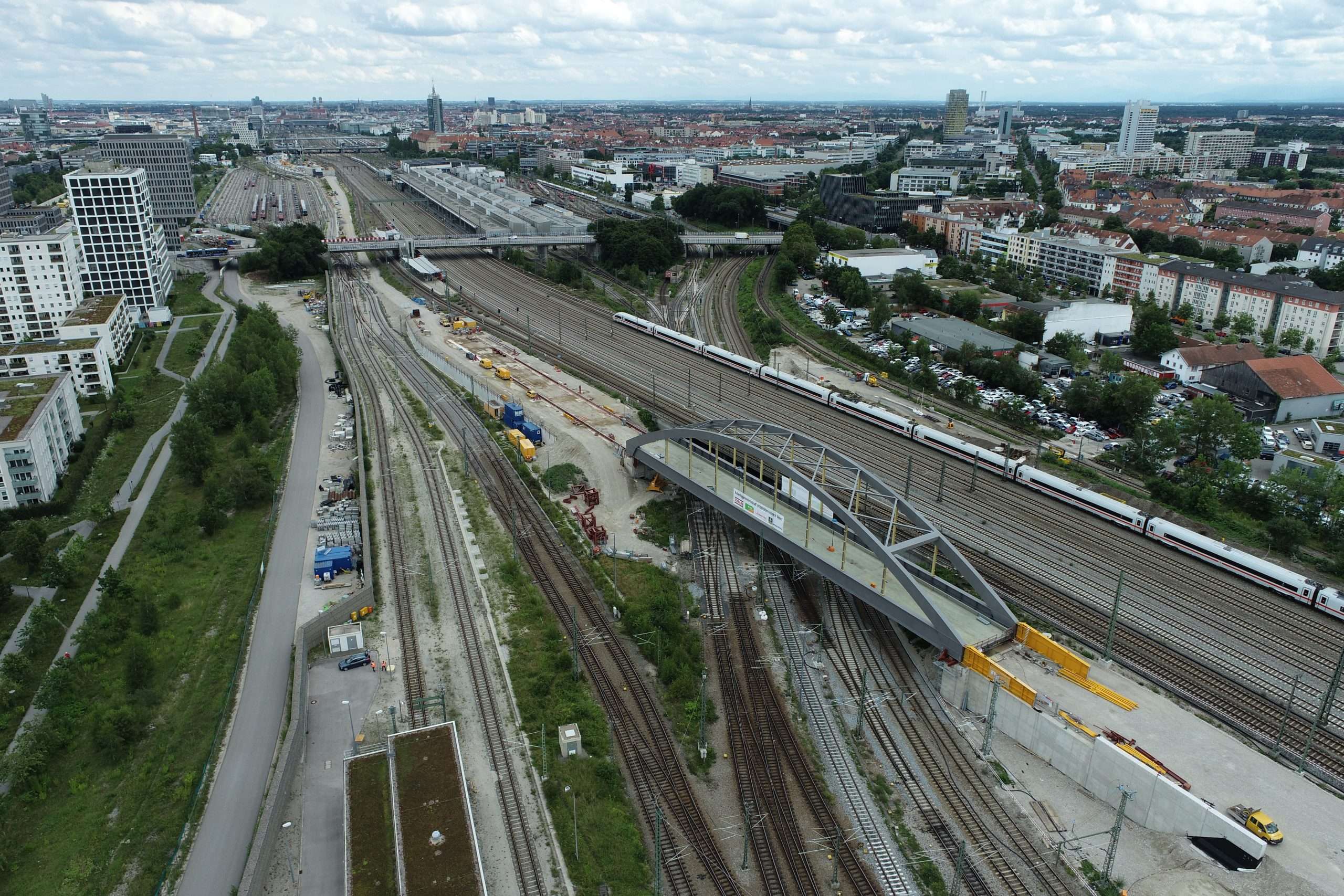 Tied-arch bridge with Munich skyline from bird's eye view