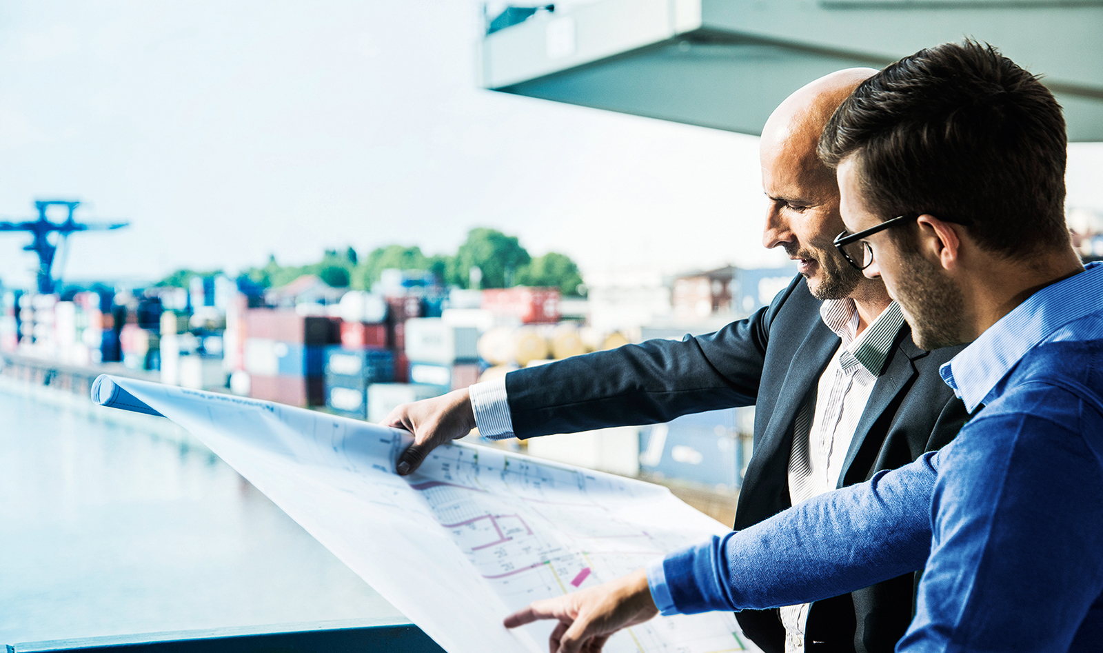 company history_Construction design meeting at container terminal_Westend61 via Getty Images